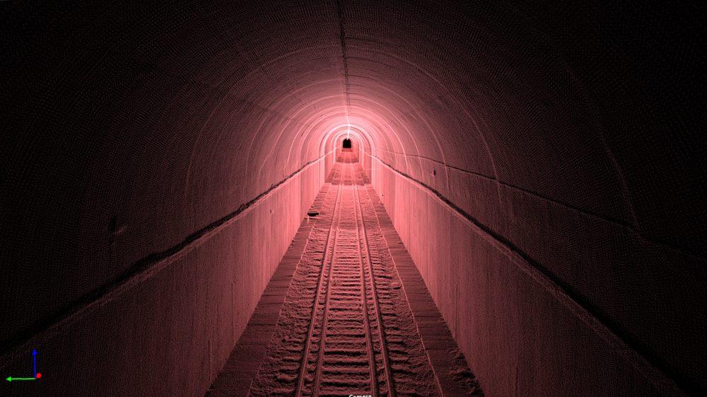 Point cloud looking along a tunnel bore towards the far opening, the lining and track picked out in detail